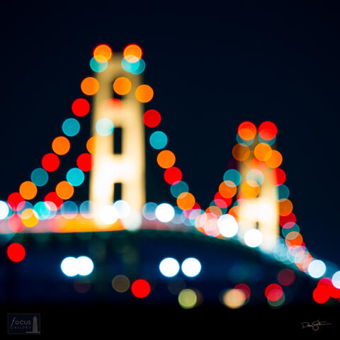 Lights on the Mackinac Bridge at night taken out of focus.