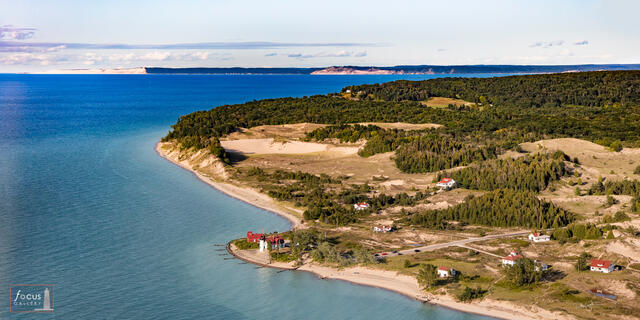 Aerial view of Point Betsie Lighthouse, Empire Bluffs and Sleeping Bear Dune over Lake Michigan.