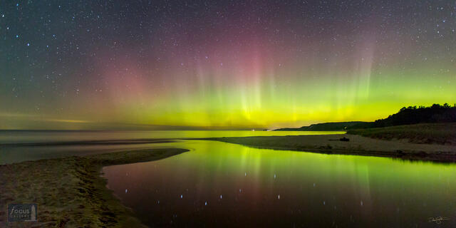 Big Dipper and its reflection with aurora borealis at Herring Creek Outlet, Lake Michigan, Benzie County, Michigan.