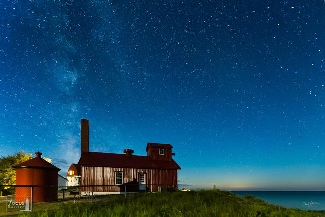 Starry skies over the fog signal building at the Point Betsie Lighthouse in Benzie County, Michigan.
