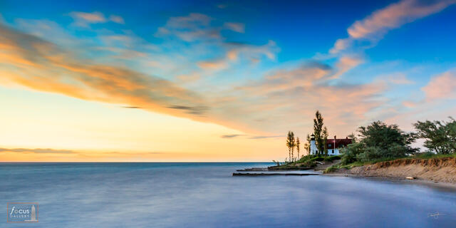 Sunset colors over Lake Michigan and Point Betsie Lighthouse.