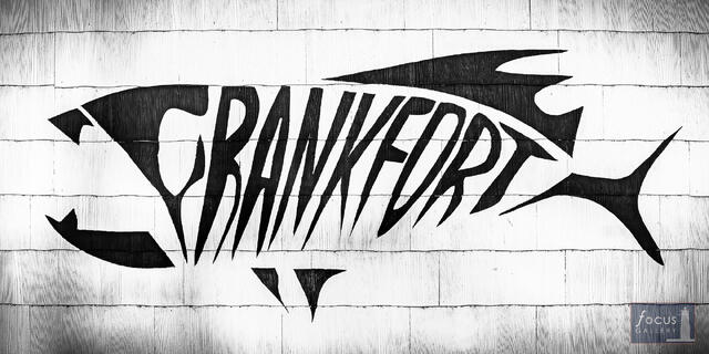Hand-painted fish skeleton sign spelling Frankfort on storefront, downtown Frankfort Michigan
