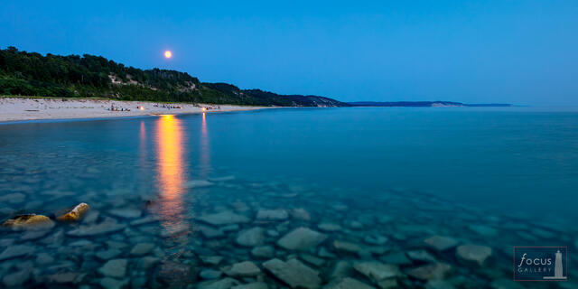 Moonrise over Lake Michigan at dusk with campfire reflection, Elberta Beach, Michigan