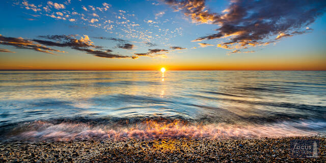 Lake Michigan sunset over pebble beach at Point Betsie, Frankfort, Michigan