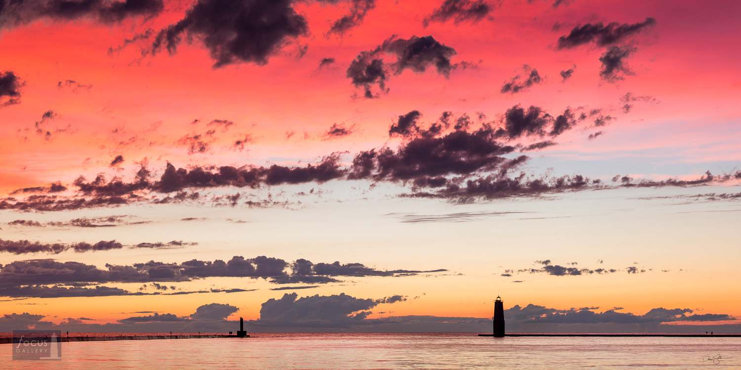 Colorful sunset over Frankfort Harbor and Lake Michigan.
