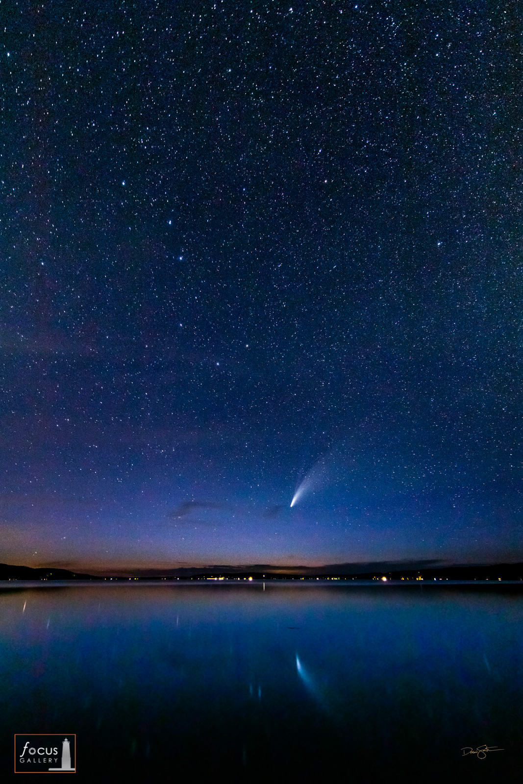 Comet NEOWISE with the Big Dipper and lots of stars in the night sky over Crystal Lake, Michigan.