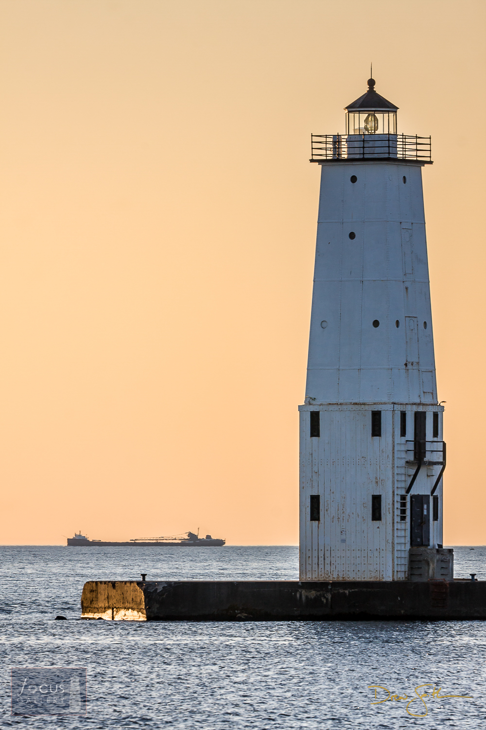 Ore freighter and the Frankfort North Breakwater Lighthouse, a classic Great Lakes image