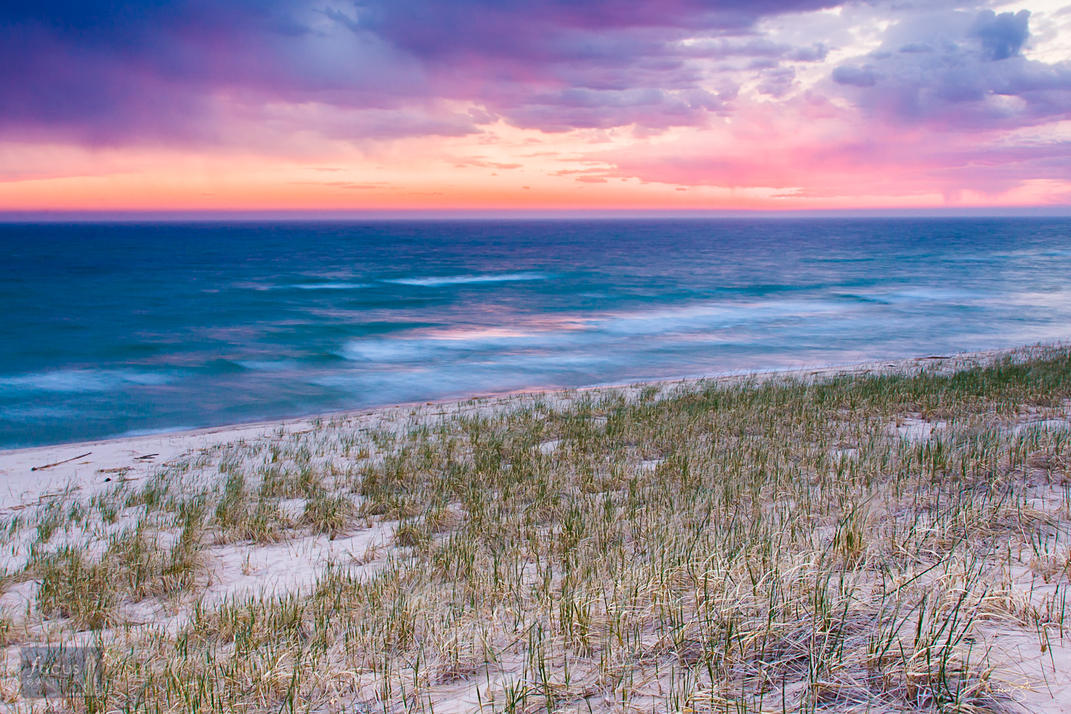 Pastel colored sunset over Lake Michigan at Grace Road Beach, Elberta, Michigan.