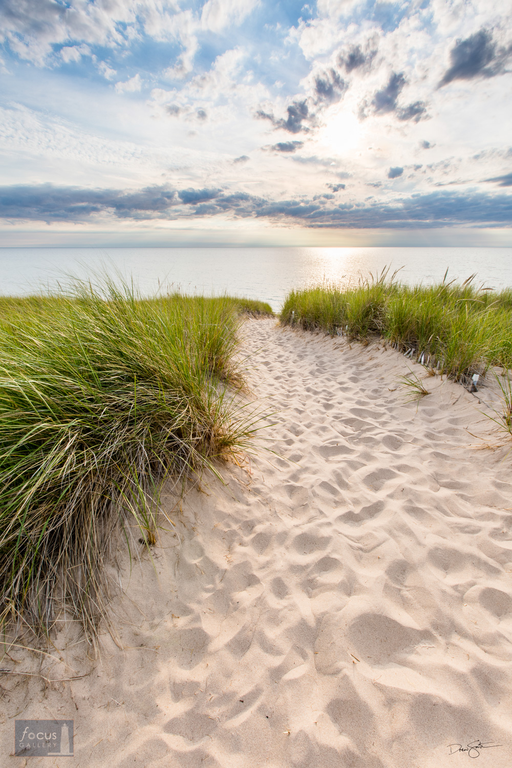 Sandy pathway through dunes to shore of Lake Michigan.