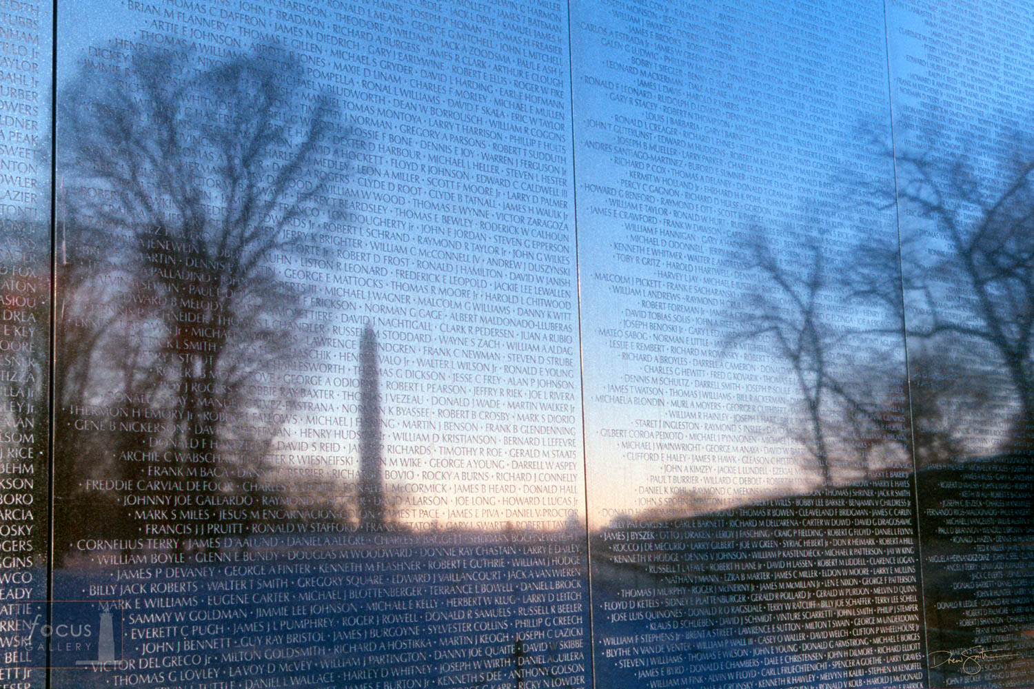 Photo © Drew Smith The Washington Monument reflected in the Vietnam Veterans Memorial Wall at sunrise.