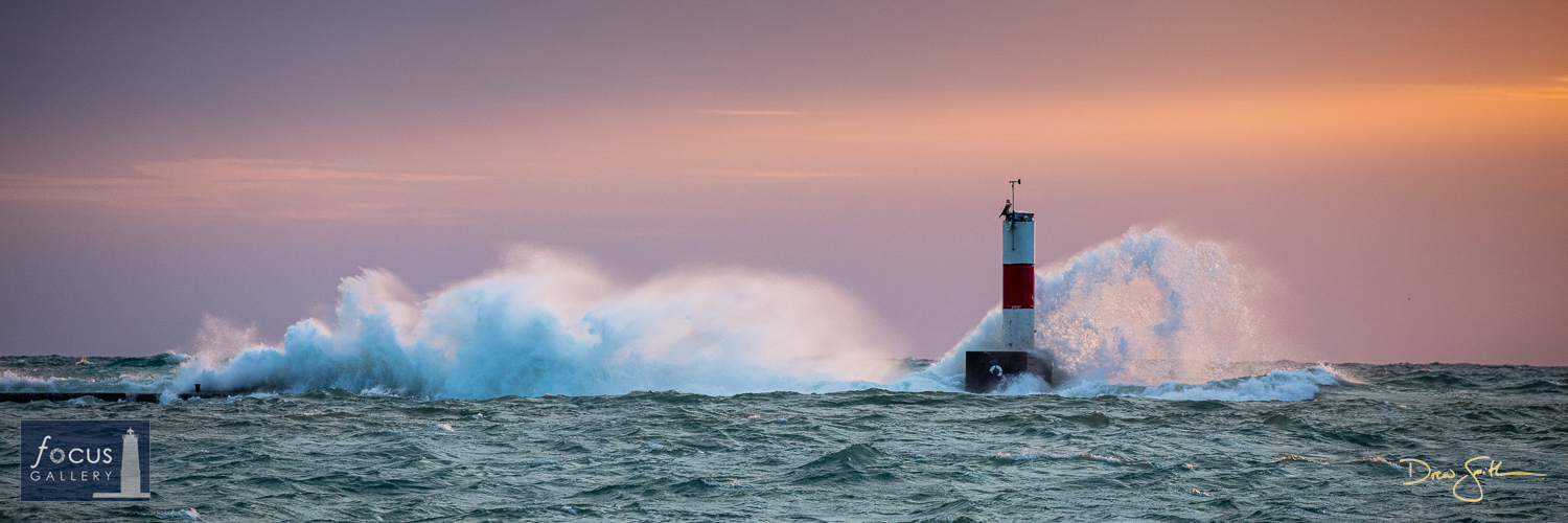 Photo © Drew Smith Waves crash against the Elberta pier and lighthouse at the entrance to Frankfort Harbor.