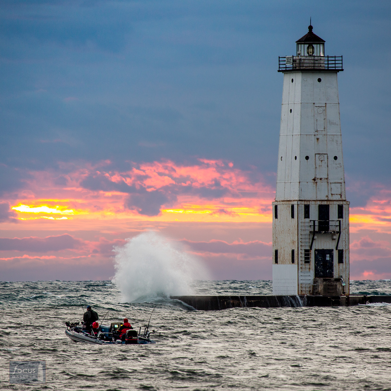 Fishing boat at sunset on Lake Michigan with waves crashing at Frankfort lighthouse.