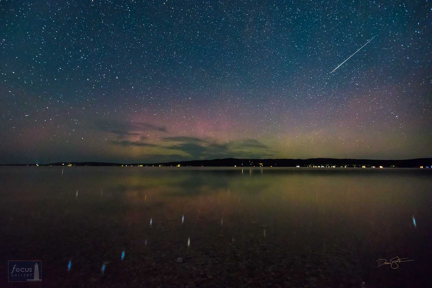Starry skies with Big Dipper and a meteor reflecting on Crystal Lake with aurora borealis.