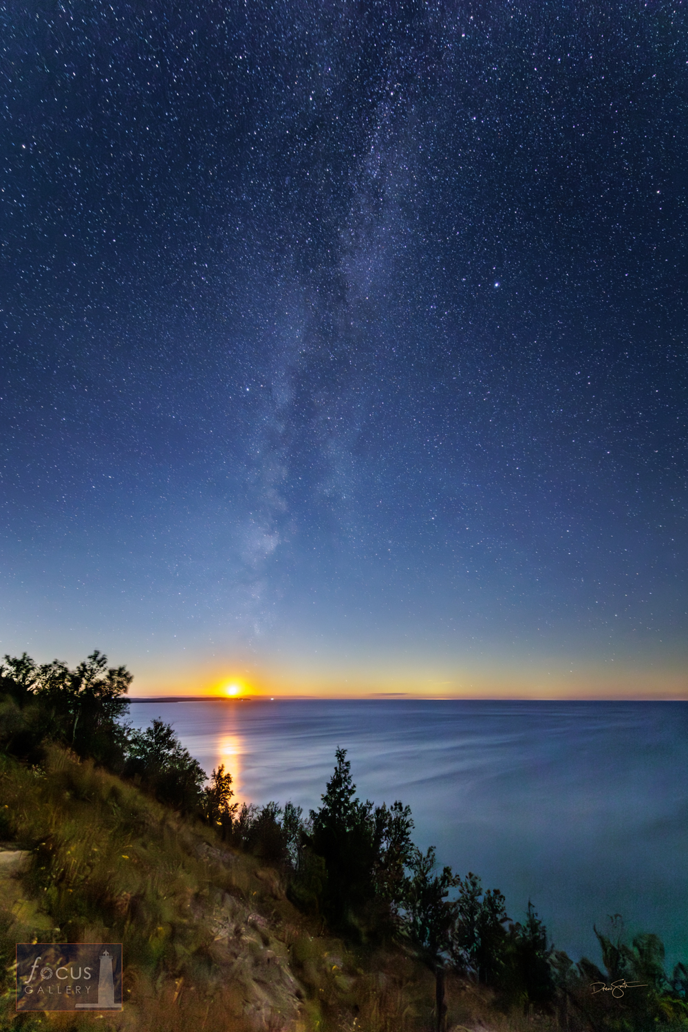 The moon   sets over Platte Bay as the Milky Way and a sky full of stars shines over   Lake Michigan.